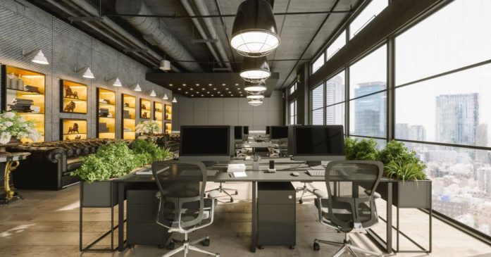 Interior of a modern luxurious open plan office space with dark gray furniture and city view.